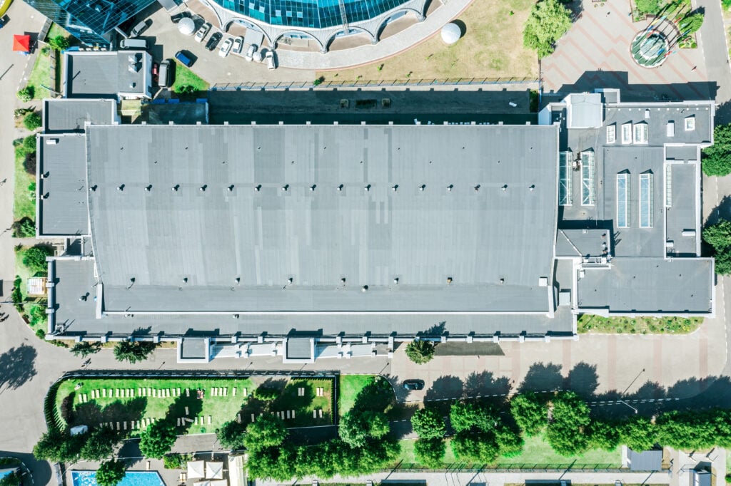 shingle roof of modern building with ventilation systems and skylights. aerial top view