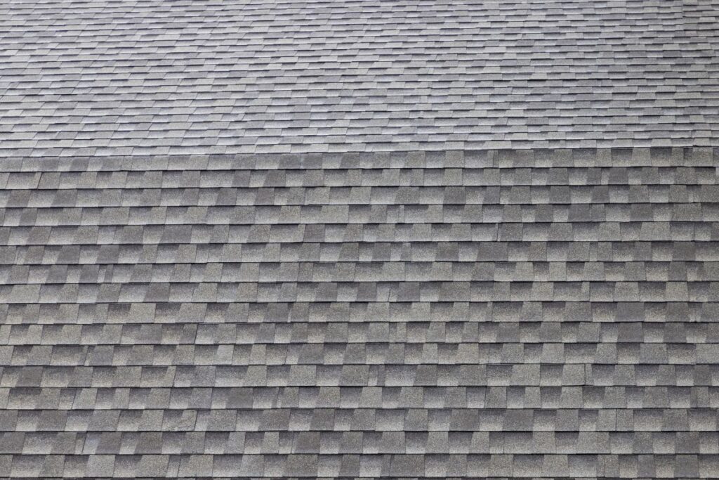 wet roof shingles background and texture. angle slop of asphalt roof.