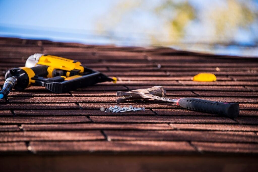 close-up of roofing tools on a shingle roof